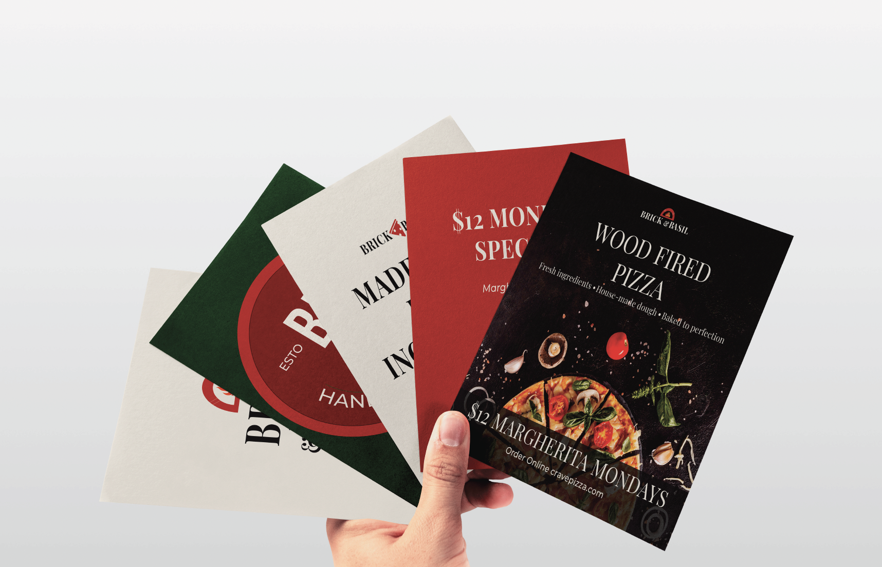 Brick & Basil Brand System: 5 logo variations (wordmark horizontal, wordmark stacked, script with tagline, BB monogram circle, pizza-slice icon wordmark), 4-color palette (Tomato Red #C0392B, Basil Green #2E7D32, Charcoal #222222, Cream #F5EFE6), 4 typography specimens (Playfair Display, Montserrat Regular, Girl Vibes script, Bebas Neue).
